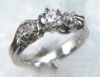 Item# CD26:Platinum engagement ring with hand carved green gold ivy leaves. The piece is set with a .54ct round brilliant center stone and two .10ct side stones.</b><br>Photo 26 of 38