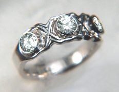 14Kt custom diamond cluster engagement/wedding ring set with a center marquise diamond, two side round diamonds and 16 diamond melee.
